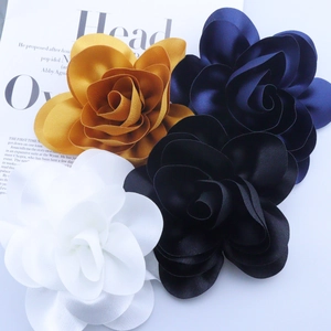 Elegant 14cm 3D satin flower brooches in gold, navy, black and white on magazine background