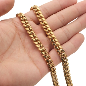 Close-up of a gold-plated stainless steel Cuban link chain necklace held in a hand