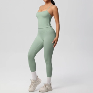 Detailed close-up of sage green high-waist yoga leggings and camisole gym set on model
