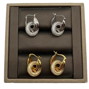 Intertwined three-ring stud earrings in gold and silver finish with sparkling zircons
