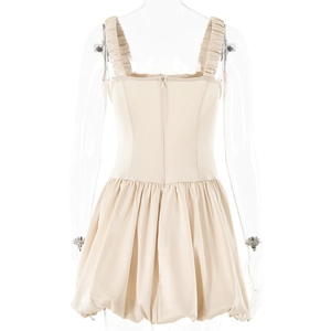 Close-up of beige satin mini dress featuring a square neck and zipper back detail
