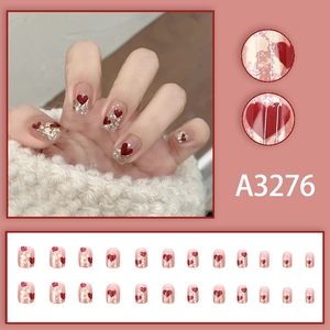 Sparkly nude pink press-on nails with red heart patterns and glitter, 24-piece full set