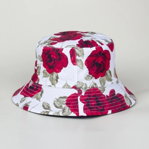 Close-up of vintage red rose floral print on a white reversible bucket hat fabric texture