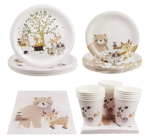 Detailed close-up of jungle animal party paper plates, cups, and napkins set with bears