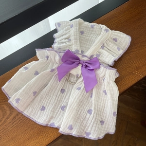 Detail of white cotton pet harness dress with purple heart prints and satin bow