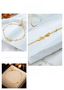 Detailed views of gold heart beat chain anklet with delicate beads and adjustable clasp