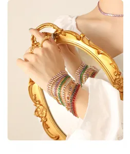 Detail of colorful cubic zirconia tennis bracelets and woven rings on model