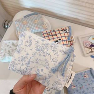 Close-up of cute cartoon cotton mini pouches for earphones and lipstick storage