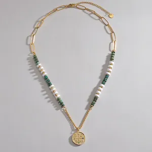 Gold beaded necklace with marble-textured beads and rhinestone-studded coin pendant