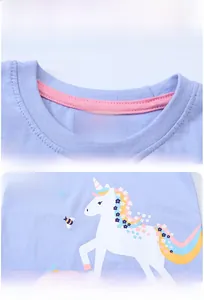 Detail view of purple cotton t-shirt with unicorn prints and classic round neckline