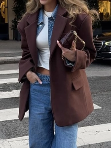 Elegant brown long-sleeved blazer jacket for women shown in a stylish street fashion view