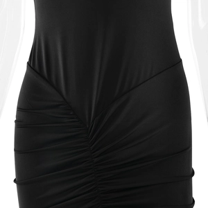 Close-up of the gathered waist and twisted knot detail on this black bodycon dress