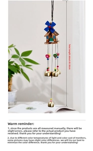 Detail of a Japanese style house wind chime with blue windmill and copper bells