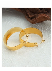Macro view of 18K gold plated wide hoop earrings with a polished metallic finish