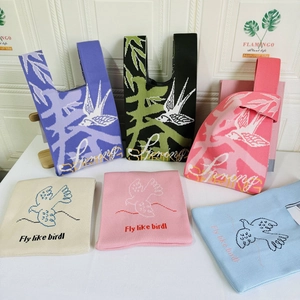 Detailed view of assorted knitted tote bags featuring bird patterns and spring motifs