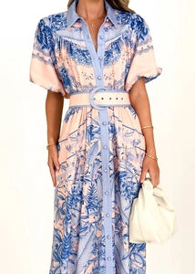 Detail of floral print dress with stand-up collar and button-down ruffled bodice