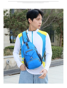 Outdoor model wearing blue nylon crossbody bag featuring front zipper and buckle strap