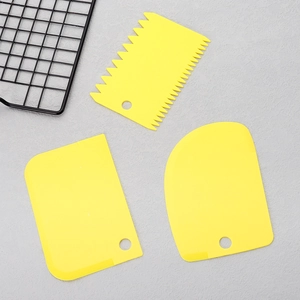 Set of 3 yellow food-grade plastic dough scrapers with straight, serrated and D-shaped edges