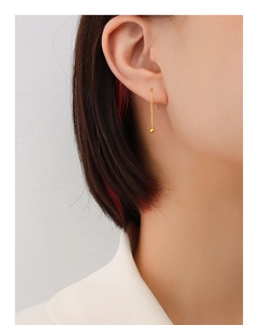 Close-up of minimalist 18K gold plated titanium ear threader with delicate chain beads