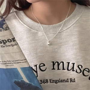 Minimalist 925 sterling silver ball pendant necklace styled with a casual outfit