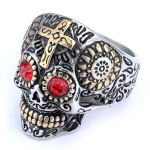 Gothic stainless steel skull ring with gold cross and red gemstone eyes on white background