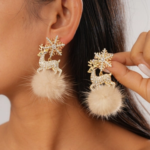Detail of Christmas reindeer earring with sparkling rhinestones and beige plush pompom