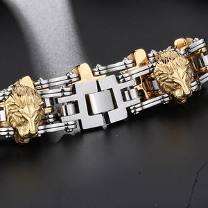 Macro detail of lion head carvings on two-tone gold and silver steel bike chain bracelet