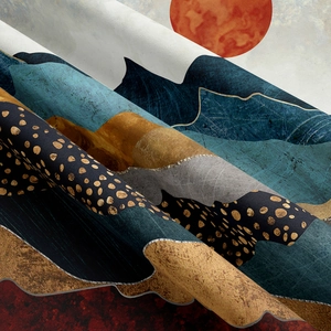 Close-up of modern tapestry fabric featuring abstract mountains and a red sun design