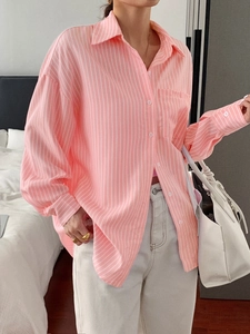 Detail of pink and white vertical striped long-sleeved shirt with front pocket and collar