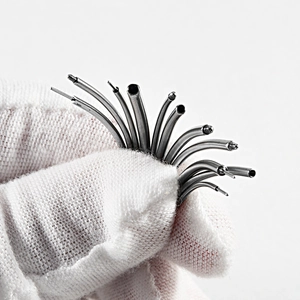 Close-up of 316L stainless steel internal thread piercing needles held in a gloved hand