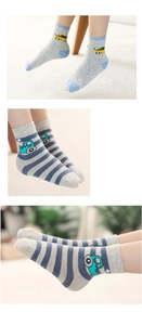Detail of baby boys' knit crew socks featuring cartoon truck patterns and ribbed cuffs