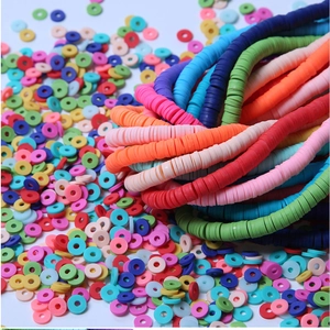 Close-up of vibrant 4mm and 6mm polymer clay disc beads for colorful DIY jewelry making