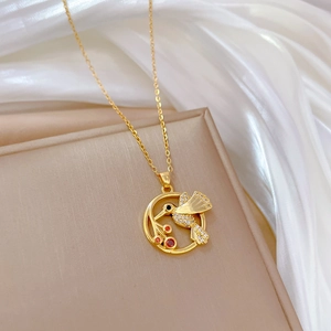 Gold hummingbird pendant necklace with sparkling cubic zirconia and orange gemstones