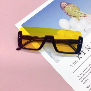 Fashionable oversized kids sunglasses with black chunky frames and yellow lenses