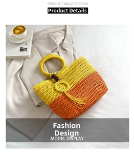 Detailed close-up of handmade straw tote bag with gradient orange weave and tassel detail