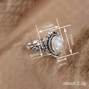 Vintage oxidized silver ring with synthetic opal and intricate floral engraving