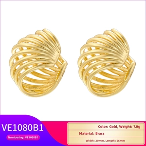 Detailed view of gold brass hollow C-shaped earrings with textured rib pattern