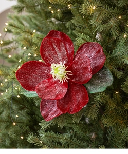 Detail of red velvet magnolia flower with silver glitter and lights for Christmas trees