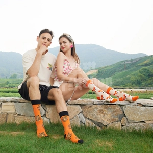 Outdoor lifestyle shot of vibrant tiger and fox patterned crew socks on models