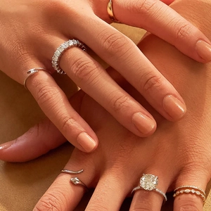 Detail showing stacked S925 silver rings with turquoise and diamonds on model fingers