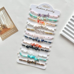 Detailed set of 11 colorful crystal gemstone beaded bracelets on a fashion display card