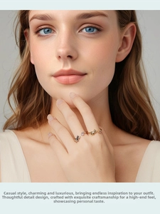 Close-up of cat and fox rings with pink heart gemstone on a hand model