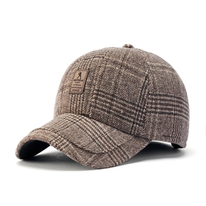 Classic brown plaid wool baseball cap with a premium leather patch on a clean white background
