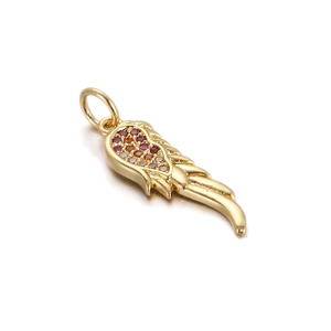 Close-up of a gold angel wing pendant with red and clear gems for DIY jewelry
