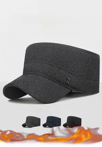 Close-up of winter flat top cap featuring thick tweed fabric and metal Z decoration