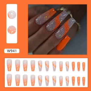 Detail of medium-long coffin nails in orange and glitter showing full 24-piece set
