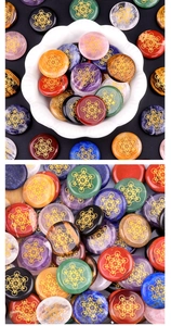 Detailed macro view of assorted crystal discs with engraved golden sacred geometry symbols