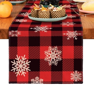 Close-up of red and black buffalo plaid table runner with white snowflake prints