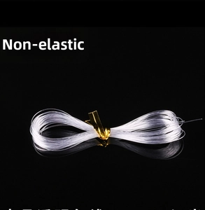 Clear non-elastic beading wire roll with gold binding for handmade jewelry crafting