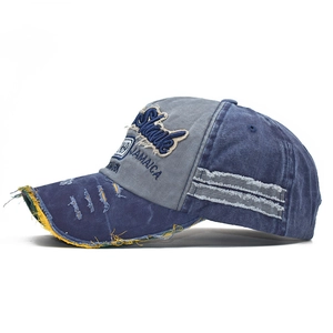 Detail of washed canvas baseball cap featuring vintage frayed edges and 1989 embroidery